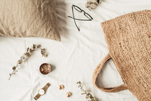 Frame With Copy Space Made Of Fashion Women Accessories, Straw Bag, Pillow, Eucalyptus Branches On White Linen. Flat Lay, Top View Blank Mockup Concept For Social Media, Website, Blog.