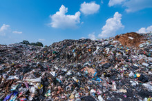 The Mountain Of Plastic Waste From Urban Communities And Industrial Districts And The Blue Sky