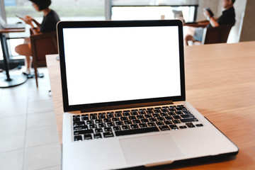 mockup image computer,cell phone blank screen for hand typing text,using laptop contact business searching information in workplace on desk at office.design creative work space on wooden desk