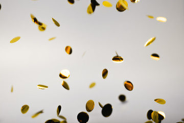 Poster - Golden falling confetti on grey background. Holiday concept.