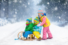 Kids Play In Snow. Winter Sleigh Ride For Children