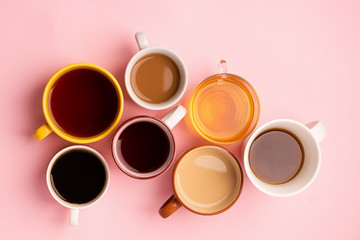 Mugs glasses with various traditional drinks coffee tea juice on pink background. Flat layout top view. Drinks concept.