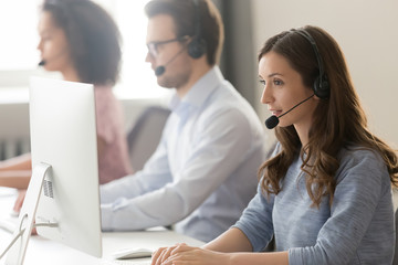 Wall Mural - female agent in headset consult client online using pc