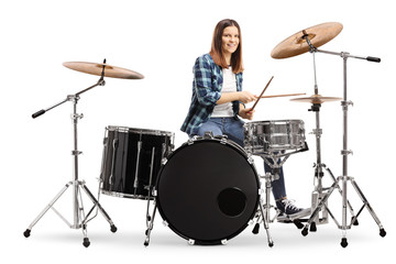 Young female learning to play drums