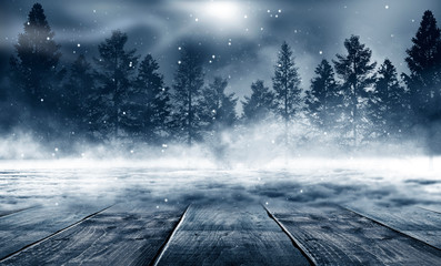 Winter background. Winter snow landscape with wooden table in front. Dark winter forest background at night. Snow, fog, moonlight. Dark neon night background in the forest with moonlight.