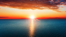 Aerial View Of Sun Rising Over Sea.
