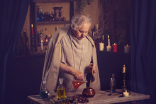 Elderly Alchemist Monk Brews  Magic Potion