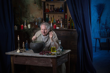 Wall Mural - elderly alchemist monk brews  magic potion