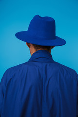 Wall Mural - Photo from back of african american man wearing hat and coat