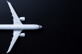 Aircraft model on black background, Top view with empty space. Concept of aircraft industry, airline safety, security and traveling insurance