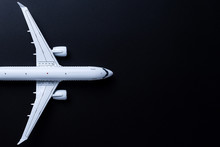 Aircraft Model On Black Background, Top View With Empty Space. Concept Of Aircraft Industry, Airline Safety, Security And Traveling Insurance