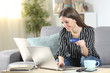 © Antonioguillem - Happy woman buying on-line using laptop and credit card