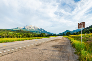 Carbondale view of mount Sopris in Colorado with empty road and nobody sign for overlook view of snow mountain peak