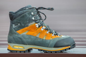 A leather trekking hiking winter boot on blurred background