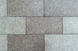 Texture of gray horizontal road granite tiles. Stone background. Modern paving slabs. Motley pattern.