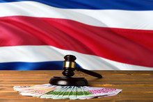 Costa Rica Bribing Concept. Law Theme, Mallet Of The Judge On Wooden Desk With National Flag Background.