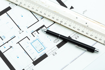 Roll of architectural blueprint house building plans on table with pencil and ruler. Home Automation building concept