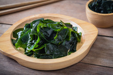 Wakame Seaweed On Wooden Plate And Dried Seaweed In Bowl