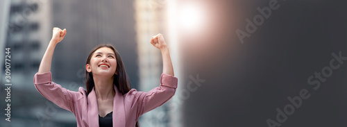Fotomural Power of woman, young Asian businesswoman raised arms motivates herself with confident