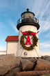 Close up of Brand Point Lighthouse, located on Nantucket Island in Massachusetts, decorated for the holidays with a Christmas wreath and crossed oars.