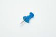 © chalongrat - Close up of Blue pin  on white background