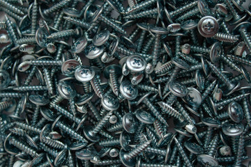 Small iron screws closeup beautifully scattered nuts