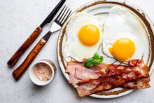 Fried Eggs And Bacon For Breakfast On A Plate, Top View, Copyspace