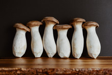 Group Of Raw King Oyster Mushroom (also Known As Eryngii) On A Wooden Cutting Kitchen Board.