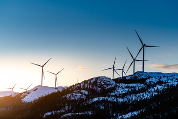 Windmill over a mountain in Fosen in Norway