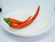 Organic Red Chili Pepper On A White Plate
