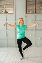 A woman is engaged in Chinese martial art in the studio. Woman and Tai Chi.