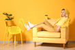 Fashionable young woman relaxing in armchair