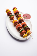 Canvas Print - Barbecue or tandoori Mushroom Tikka, served in a plate with green chutney and ketchup. selective focus