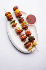 Wall Mural - Barbecue or tandoori Mushroom Tikka, served in a plate with green chutney and ketchup. selective focus