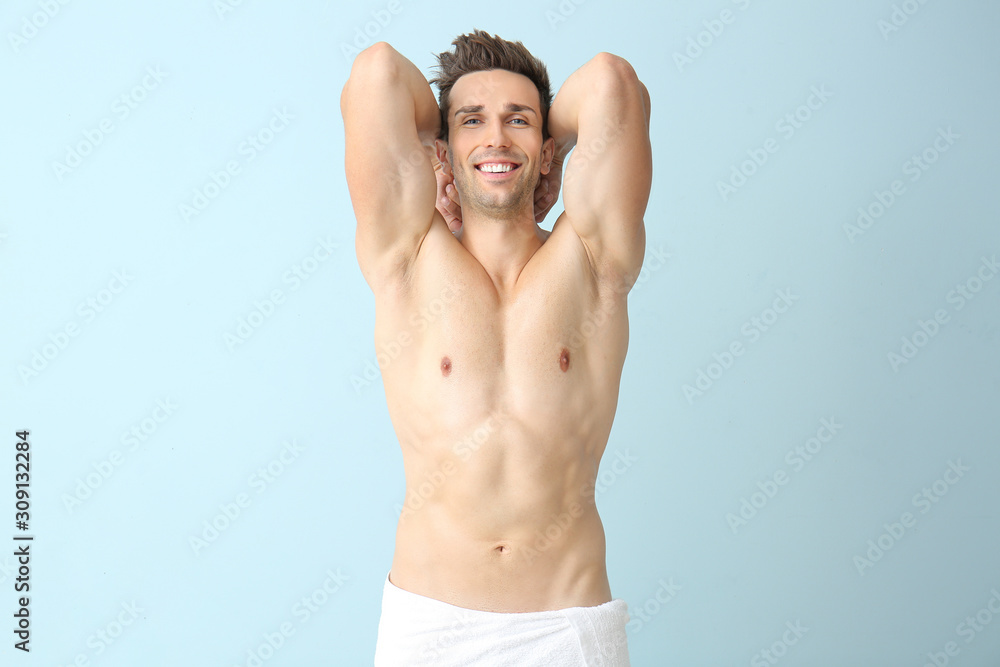 Handsome young man after depilation on color background