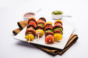 Canvas Print - Barbecue or tandoori Mushroom Tikka, served in a plate with green chutney and ketchup. selective focus