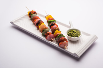 Canvas Print - Barbecue or tandoori Mushroom Tikka, served in a plate with green chutney and ketchup. selective focus