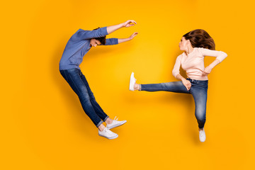 Man vs woman battle concept. Two people ninja full size photo have karate kickboxing training fight kick legs guy lose fall wear denim jeans isolated over yellow color background