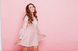 © dmitriisimakov - Portrait of a beautiful fashionable woman with hair curls in a pink dress