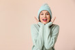 © Pixel-Shot - Happy young woman in winter clothes on light background