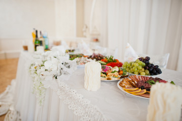 Beautiful wedding set decoration in the restaurant. Candles and flowers.