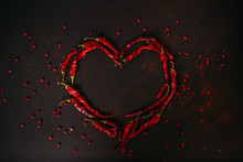 Hot Dry Red Pepper Over Black Background. Chilli Pepper Heart