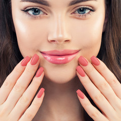 Female hand with manicured nails. Pink lips makeup and pink nailpolish, beauty manicure concept