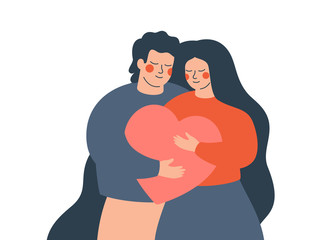 a young couple embraces each other with love and care. happy woman and man hold a big heart together