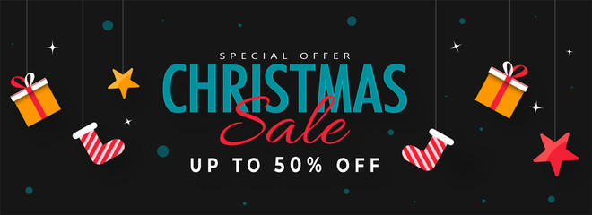 Sticker - Up TO 50% Discount Offer for Merry Christmas Banner Design with Socks, Stars, Gift Boxes Hanging on black background.