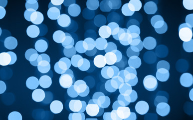 Wall Mural - holiday illumination and background concept - christmas garland with classic blue lights bokeh