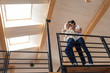 © LIGHTFIELD STUDIOS - Low angle view of young couple hugging at balcony and girl holding coffee cup