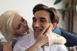 © LIGHTFIELD STUDIOS - Smiling blonde girl touching boyfriend face at home