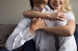 © LIGHTFIELD STUDIOS - Cropped view of young couple holding hands and hugging at home