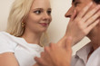 © LIGHTFIELD STUDIOS - Selective focus of smiling girl touching boyfriend face